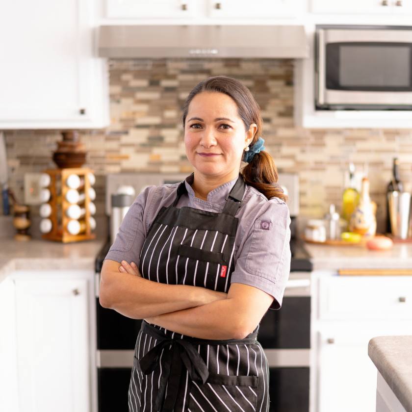 Personal Chef and Food Blogger Sujhey Beisser standing in a kitchen