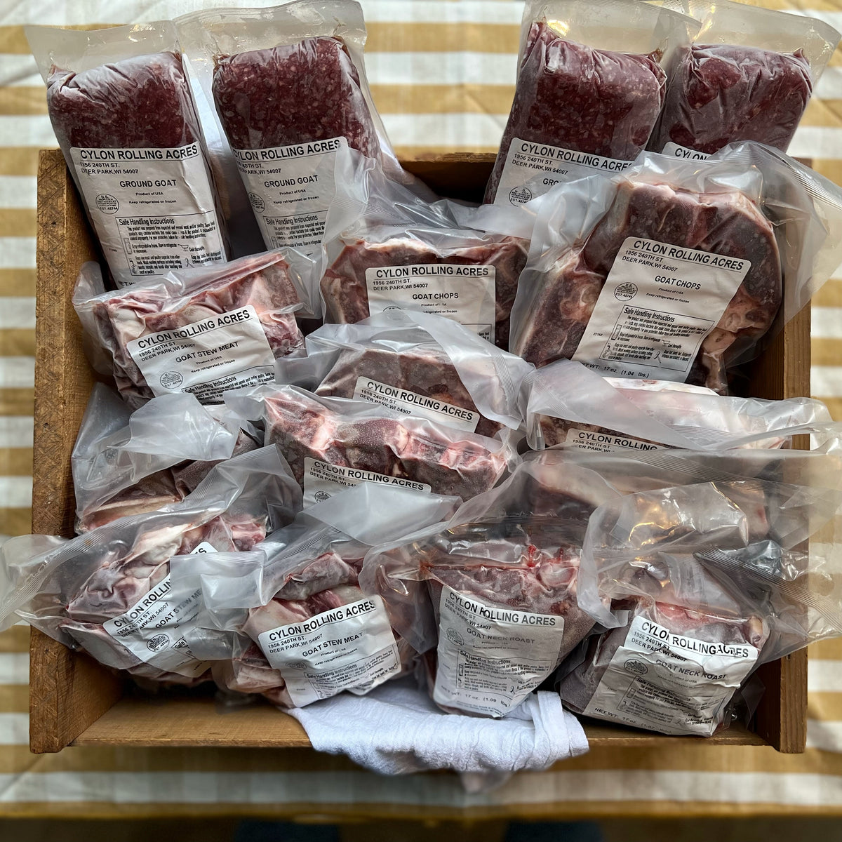 Box of various farm raised goat meat, packaged and frozen.